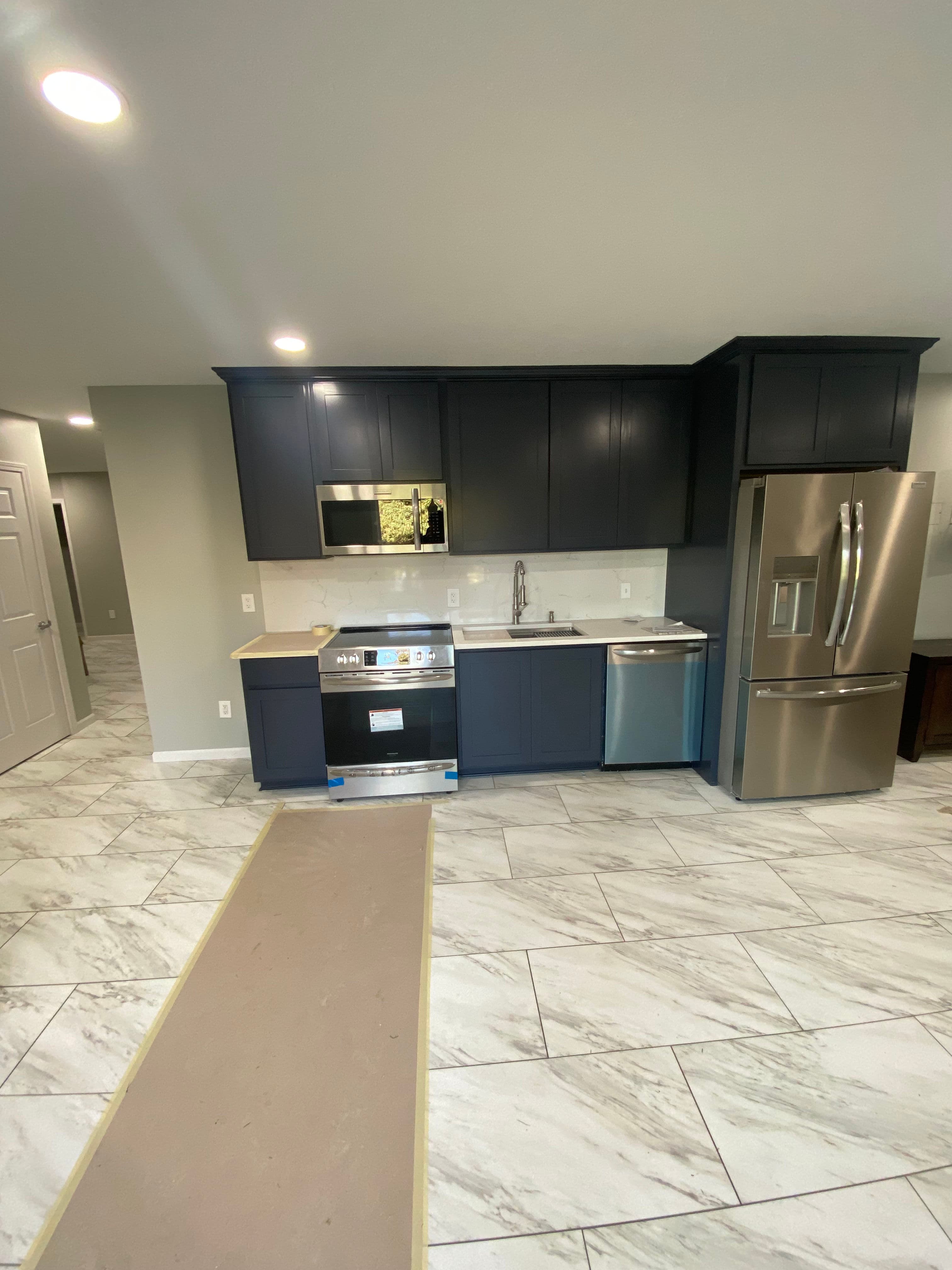 Project Dark Cabinets and Marble Floors Make This Basement Kitchen Pop image