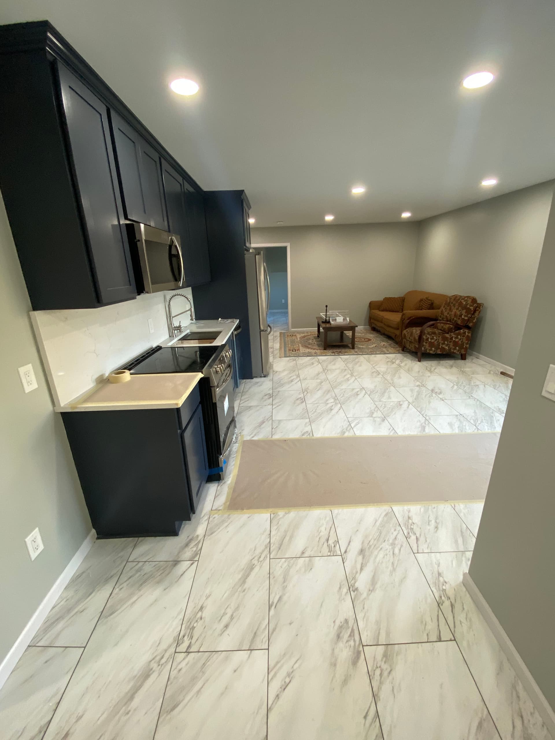 Gallery photos for Dark Cabinets and Marble Floors Make This Basement Kitchen Pop: Image #2